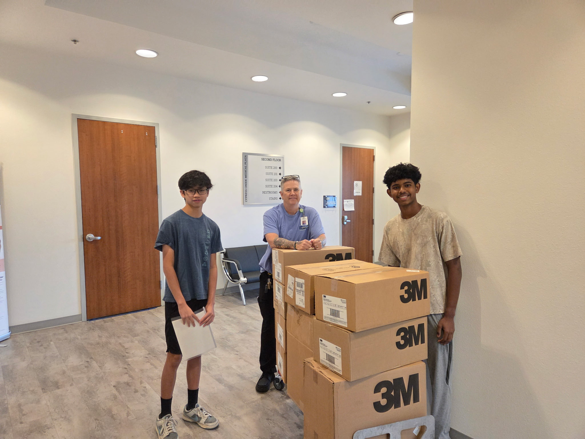 Clinical Bridge members with collected supply boxes and a healthcare professional at Cedar Park Surgery Center